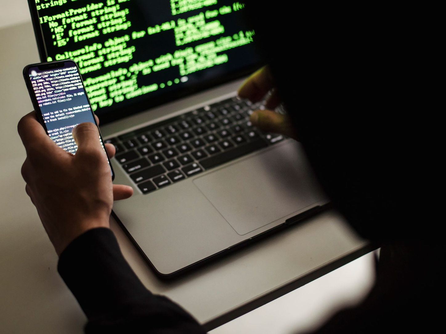 Web designer checking a site on a laptop and tablet